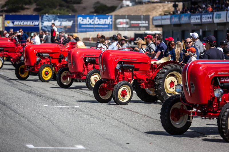 Porsche tractors in their usual red and yellow paint scheme lined up on the grid for the first race.